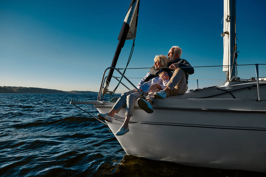 wealthy mature couple on sailing yacht